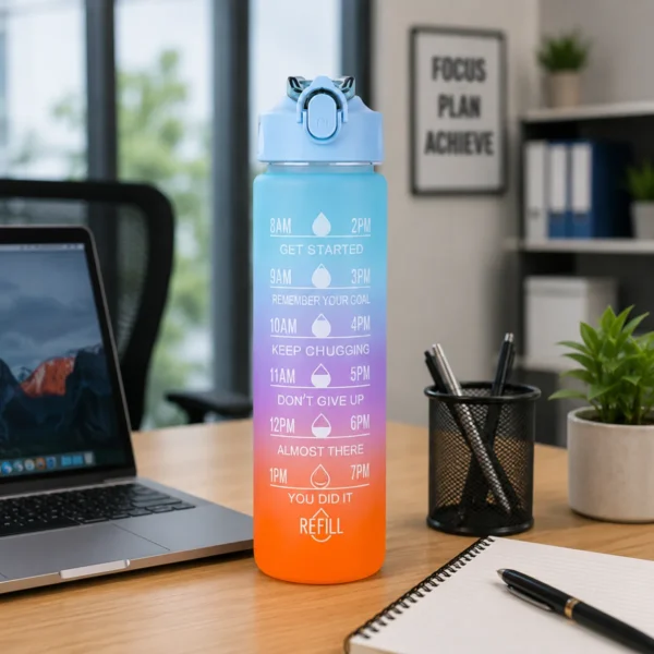 TINUMS gradient motivational water bottle placed on modern office desk with laptop and stationery