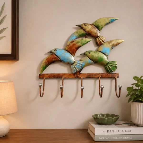 Bird design metal key hanger with 5 hooks mounted on living room wall