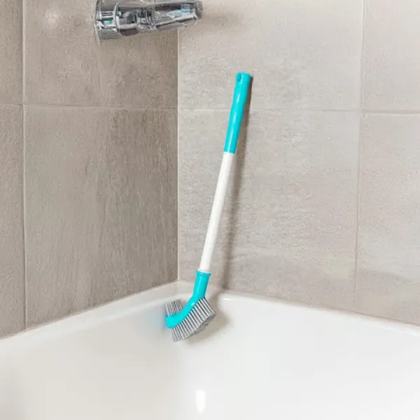 Durable bathroom toilet brush placed in shower corner for convenient storage.