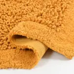 Green Tales mustard cotton bathmat with plush absorbent fibers for wet floors