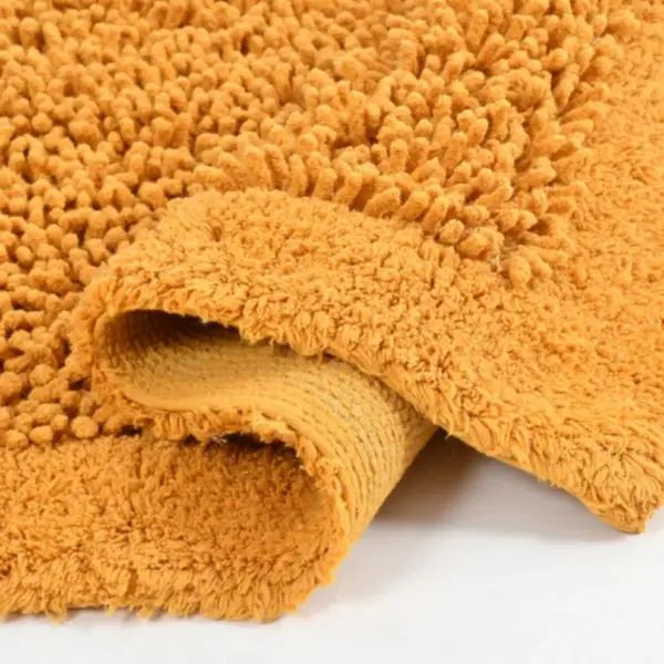 Green Tales mustard cotton bathmat with plush absorbent fibers for wet floors