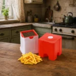 Premium French fry cutter with stainless steel blades displayed on rustic kitchen counter.