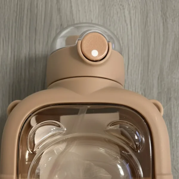 Durable teddy bear water bottle lid with secure push-button opening.