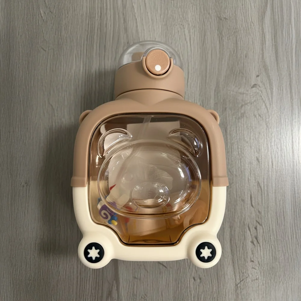 Adorable bear water bottle with clear body and easy-grip shape.