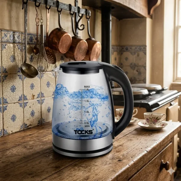 Elegant TOCKS electric glass kettle displayed on a rustic kitchen countertop.
