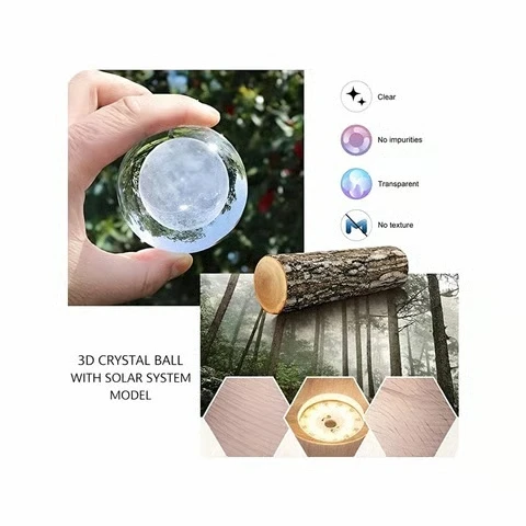 High-quality transparent crystal ball lamp with detailed solar system engraving and wooden base.