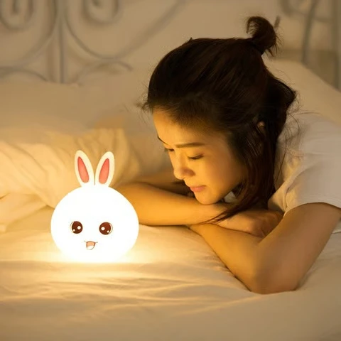 Soft glowing rabbit bedside lamp providing comforting warm light for relaxation.