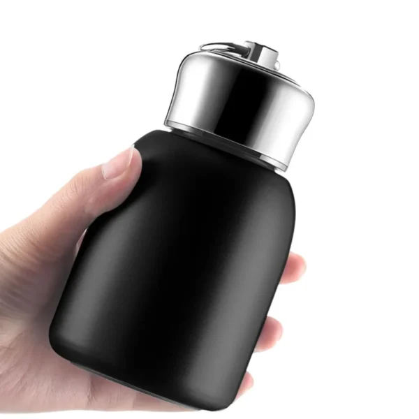 Compact reusable insulated water bottle with premium steel cap held comfortably in hand.
