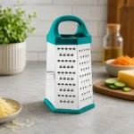 High-quality stainless steel box grater with teal handle on kitchen countertop.