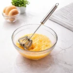 Quality stainless steel push whisk ideal for effortless batter preparation.