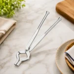 Premium stainless steel kitchen tong for safely handling hot cookware and utensils.