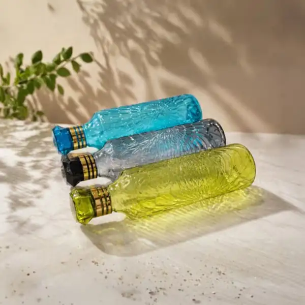 Premium textured glass bottles in three elegant colors displayed together