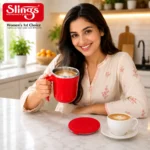 Smiling woman holding premium red insulated coffee mug in kitchen